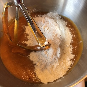 adding dry ingredients to mixing bowl
