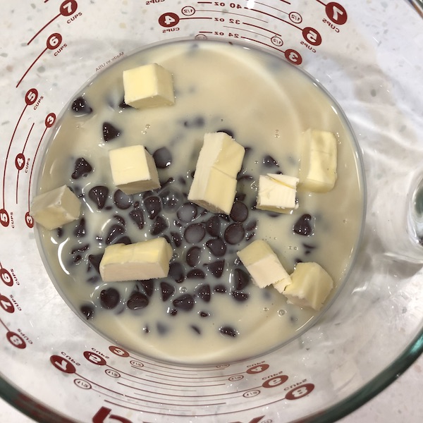 chocolate chips, sweetened condensed milk & small butter cubes in an 8 cup glass measuring cup