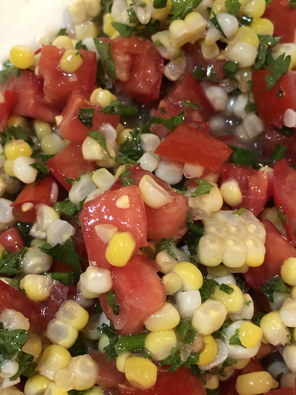 Close up of fresh corn tomato salad.