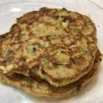 Two gluten free zucchini fritters in a stack