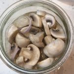 marinated mushroom salad in a glass jar.